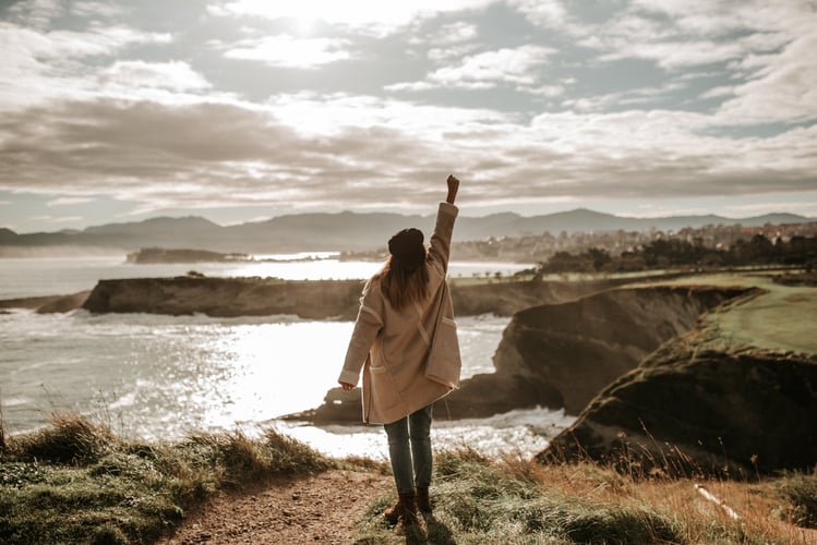 Retirement Gender Gap and financial wellness woman with high fist