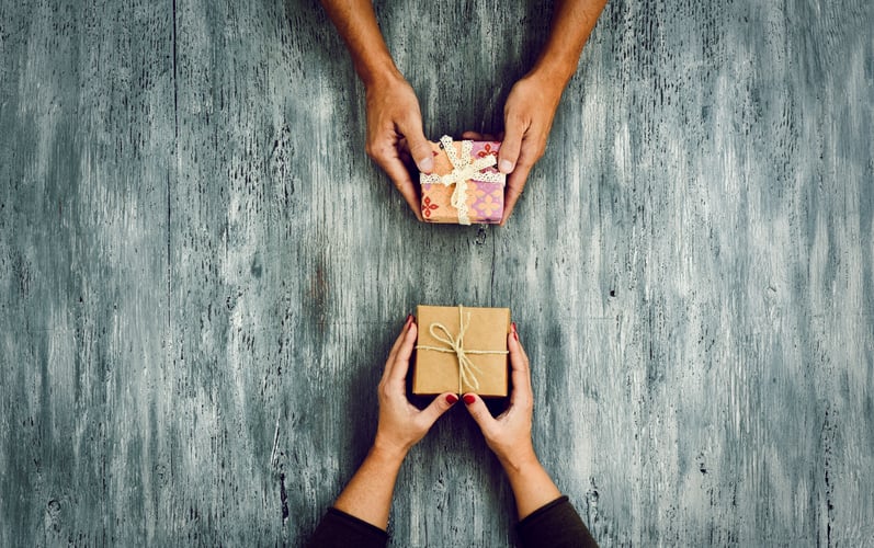 woman and man exchanging gifts