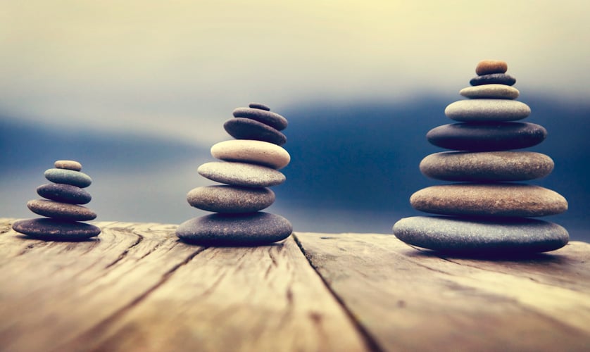 Zen Balancing Pebbles Next to a Misty Lake Concept