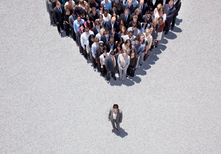 Businesswoman at apex of crowd