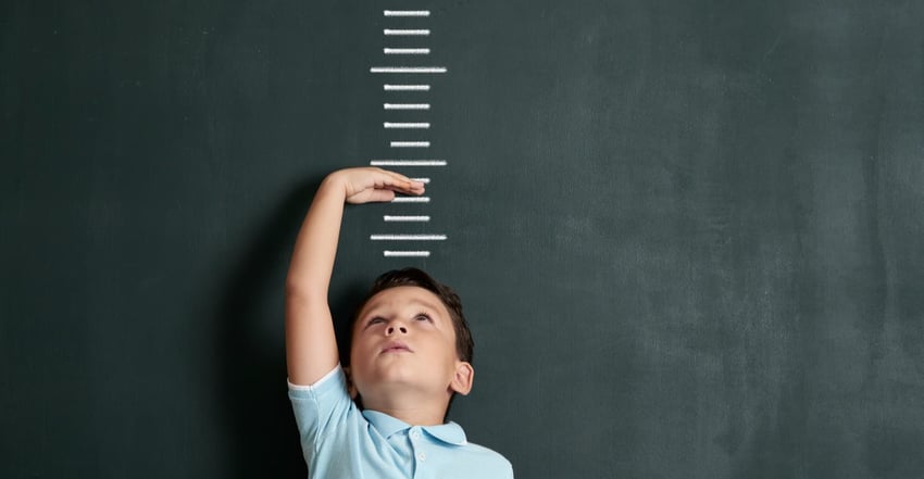 Child measuring himself