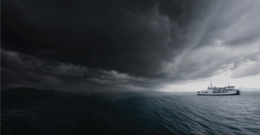 A boat on the sea approaching a storm