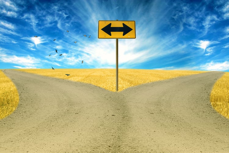 two roads, road sign ahead with arrows blue sky background.