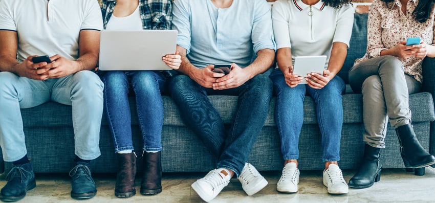 People sat on a couch reading plan participant required notices electronically