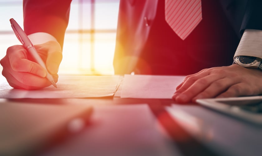 businessman signing documents
