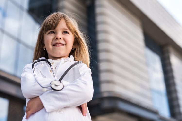 Child wearing a lab coat