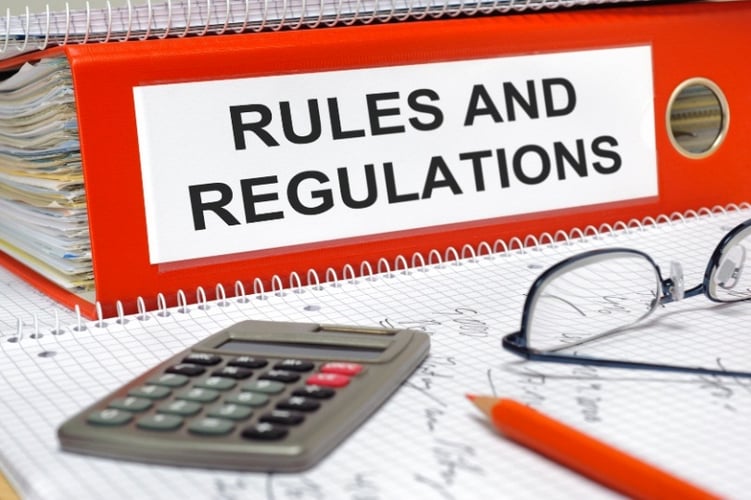 a red binder of a 60-day rollover rules and regulations