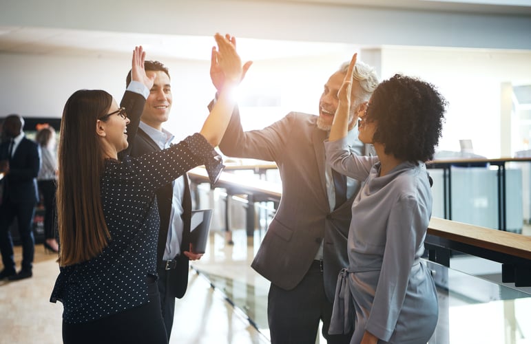 A group of people celebrating their student loan assistance program