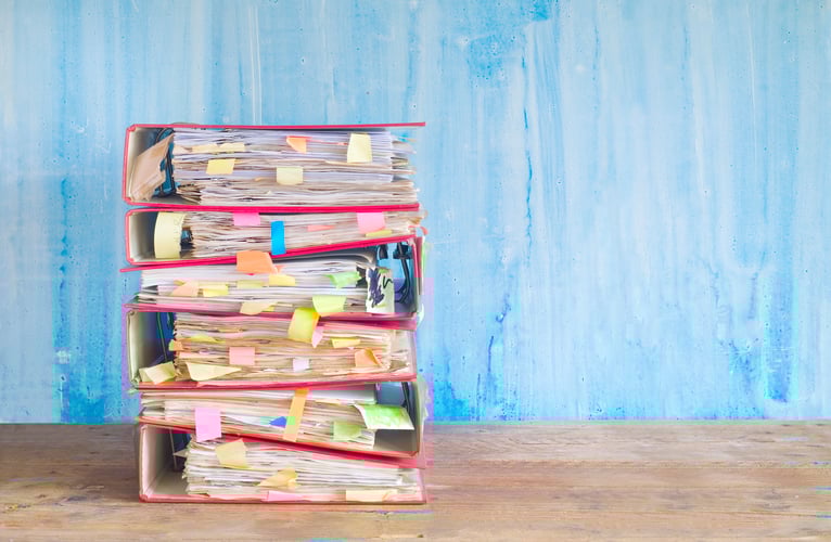 stack of messy file folders ready for a fiduciary audit