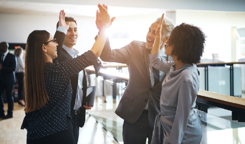 A group of people celebrating their student loan assistance program