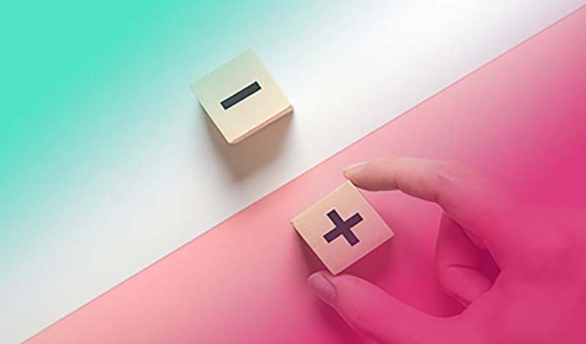 person holding plus minus cubes