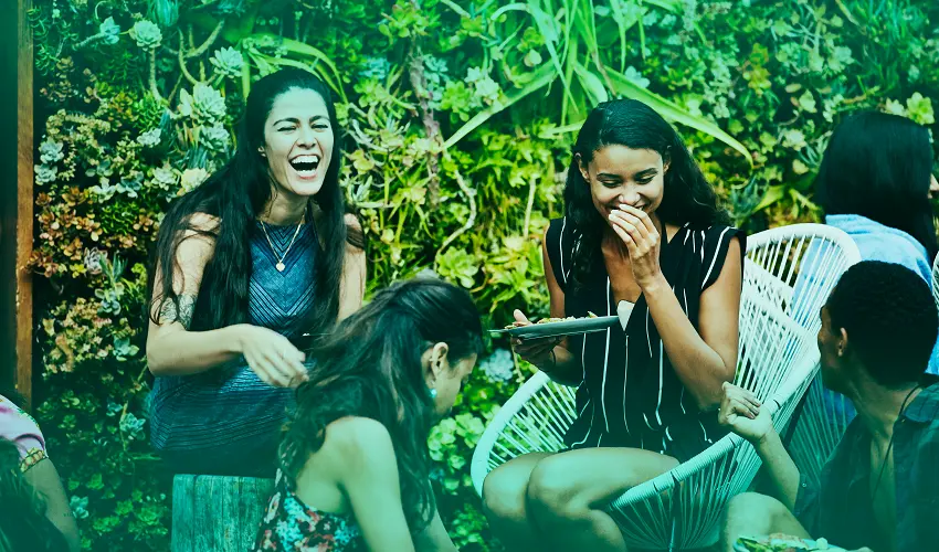 3 girls laughing while eating