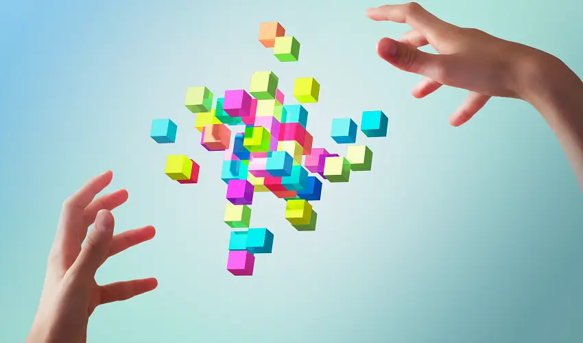 Hands controlling multicolored blocks in the air