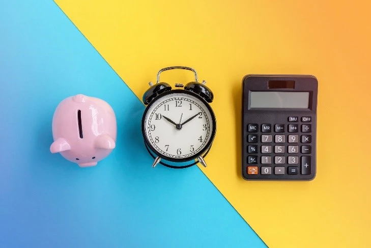 Tax Saver’s Credit: piggy bank with and alarm clock and calculator