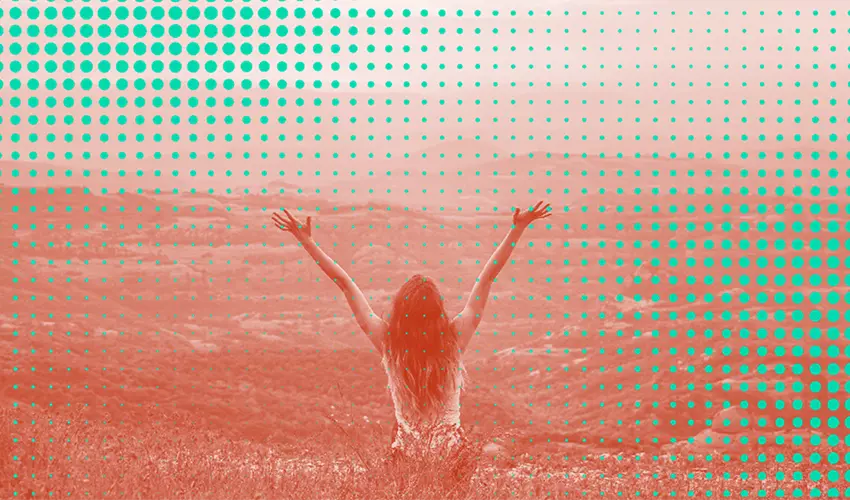 person raising both hands in the air