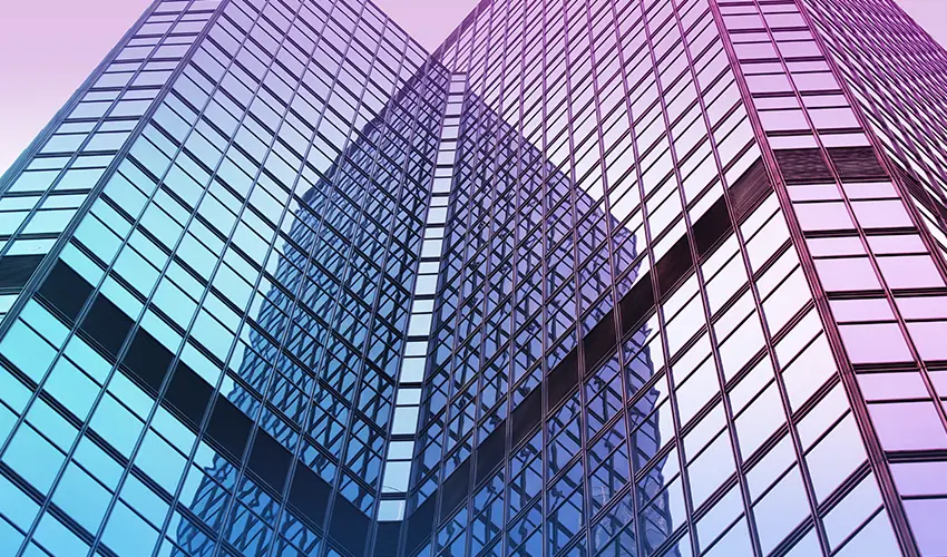 Glass skyscraper with a purple to blue gradient overlay