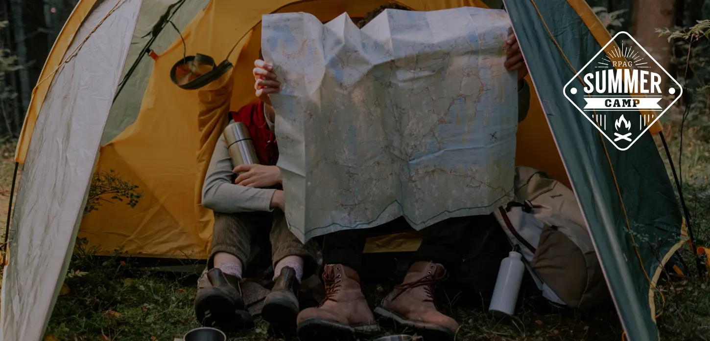 Man looking at a map in a tent